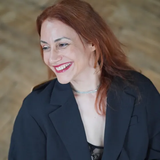 Andrea Kirste, smiling, in a dark blazer
